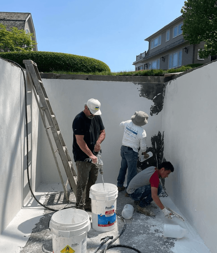 Binder Pools crew working inside an underground cistern during construction.